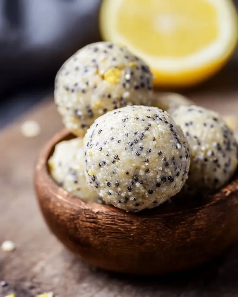 Lemon poppyseed protein balls on a wooden table with lemon slices