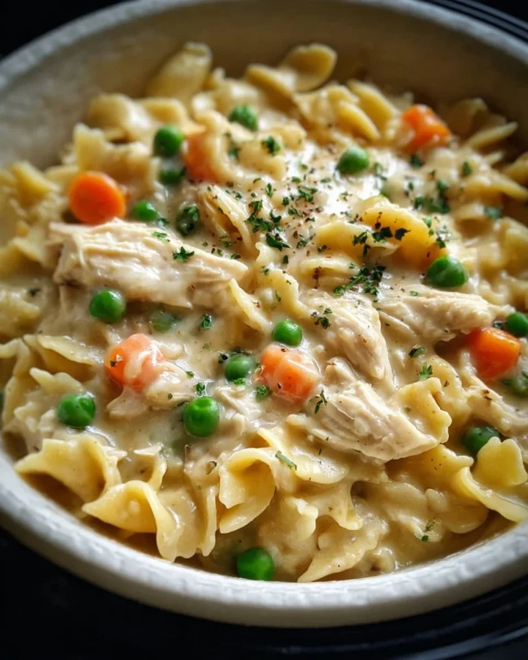 Delicious Slow Cooker Chicken Pot Pie Pasta in a bowl garnished with herbs
