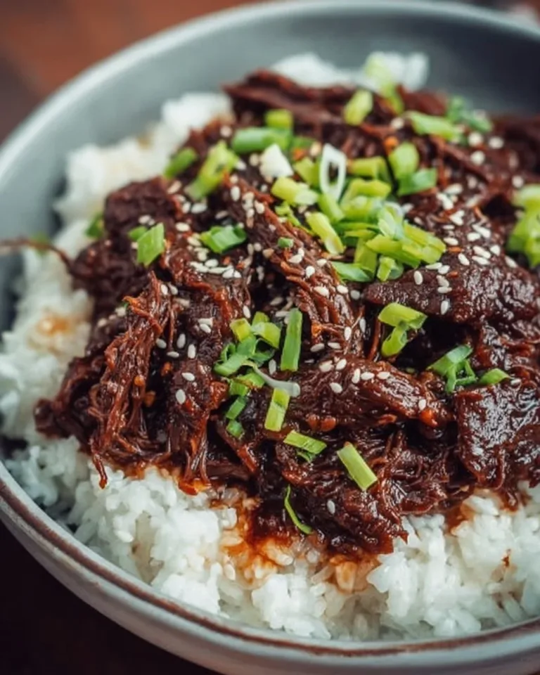 Delicious slow cooker Korean beef served with rice and vegetables.